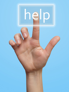 A hand pushing a Help button