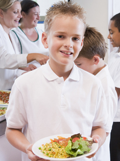 A school child with a plate of food
